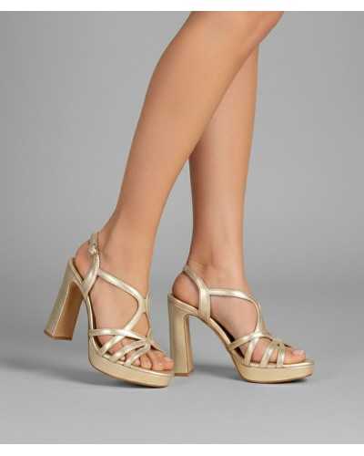 Joni gold metallic leather platform sandal block heel strappy worn on feet close up side view