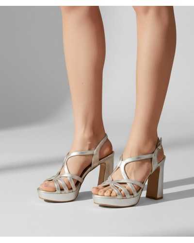 Joni silver metallic leather platform sandal block heel strappy worn on feet close up side view