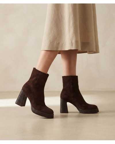 Mujer con botines Noa Harmon Divine de ante marrón y falda midi color arena